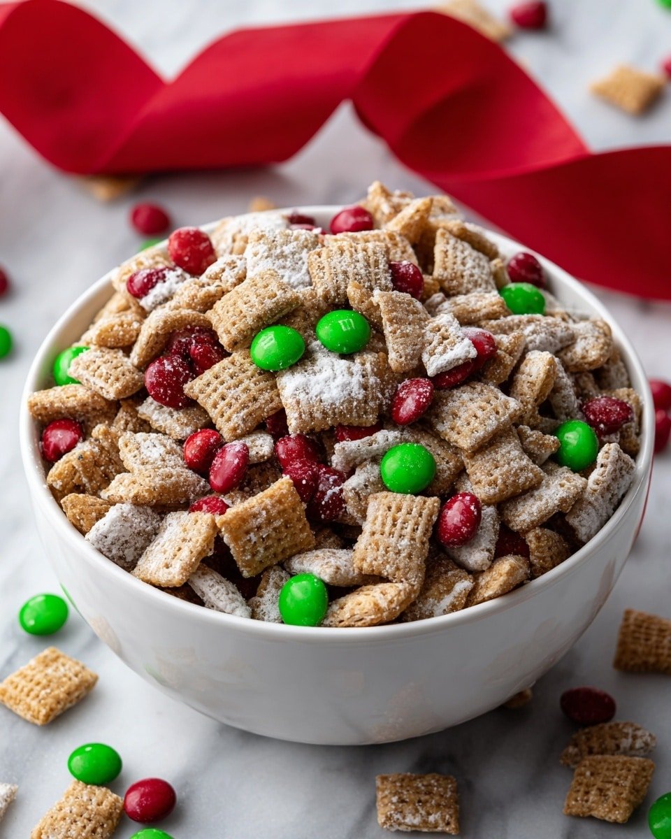A white bowl full of a snack mix with three main layers visible: the bottom and middle layers are small square cereal pieces with a light brown color and a slightly rough texture, some covered lightly in white powdered sugar. Mixed throughout these cereal pieces are smooth, round red and green candy-coated chocolates. The snack mix is heaped above the edge of the bowl, with some candies and cereal pieces scattered slightly outside. The bowl is set on a white marbled surface, with a blurred red ribbon in the background. photo taken with an iphone --ar 4:5 --v 7 — Christmas Puppy Chow, festive Puppy Chow recipe, holiday snack ideas, Christmas treats, easy holiday recipes